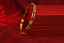 Front shot of multi-stone bangle with diamonds in 18K yellow gold