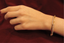 Hand shot of fine diamond bangle with alternating gold & diamond strips