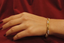 Hand shot of minimalist diamond bangle in 18K yellow gold – everyday elegance - Vansh Diamonds