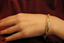 Hand shot of eternity-style diamond bangle with continuous brilliance